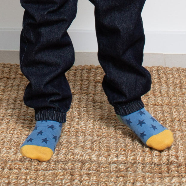 Boy in rainbow rocket socks