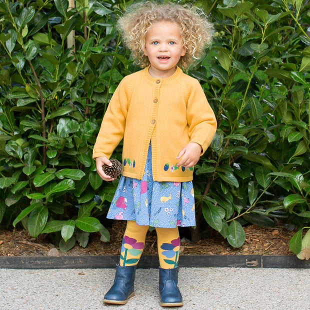 Girl in rainbow flower tights