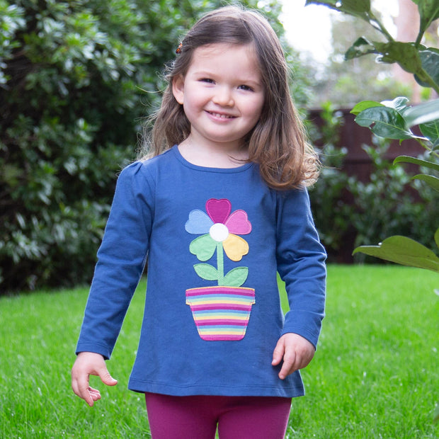 Girl in rainbow flower tunic