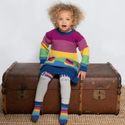 Girl in rainbow knit dress