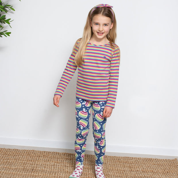 Girl in rainbow apple leggings