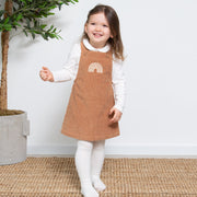Girl in jumbo cord pinafore