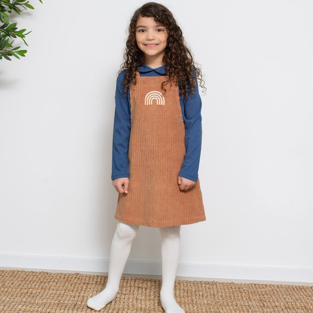 Girl in jumbo cord pinafore
