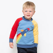 Boy in rainbow rocket sweatshirt