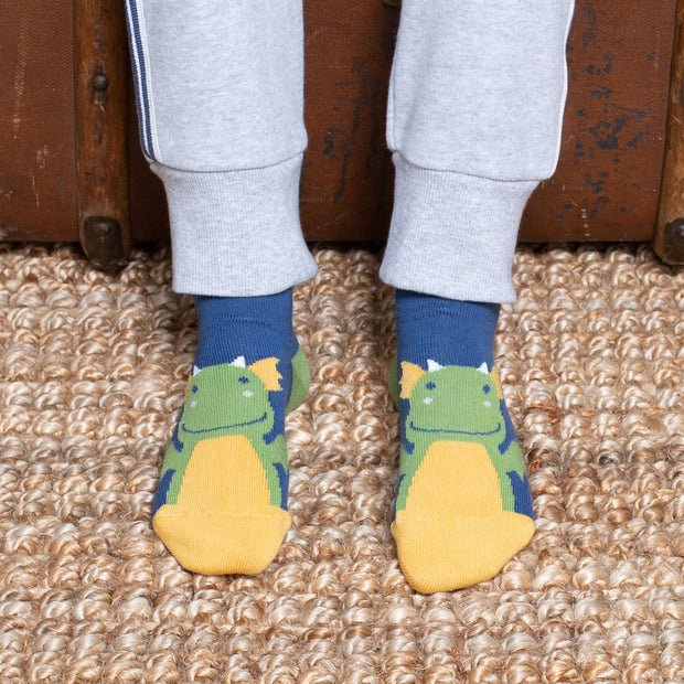Boy in little dragon socks