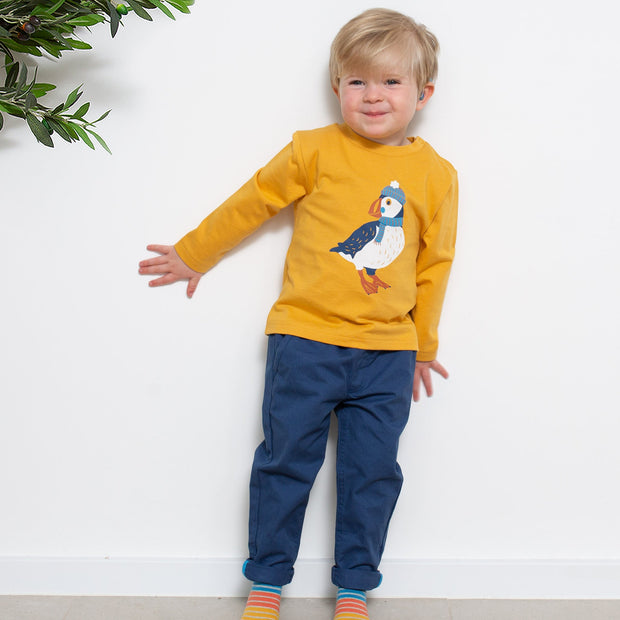 Boy in little dragon socks