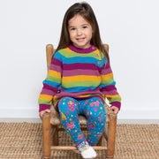 Girl in chunky rainbow jumper
