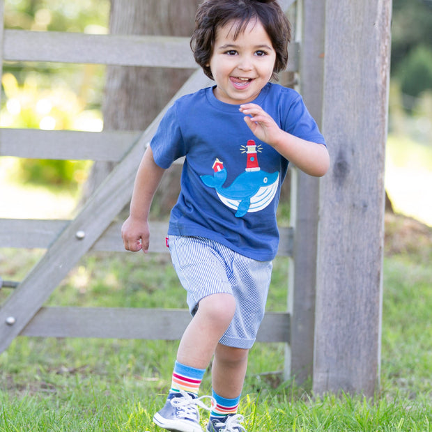 Boy in mini ticking shorts